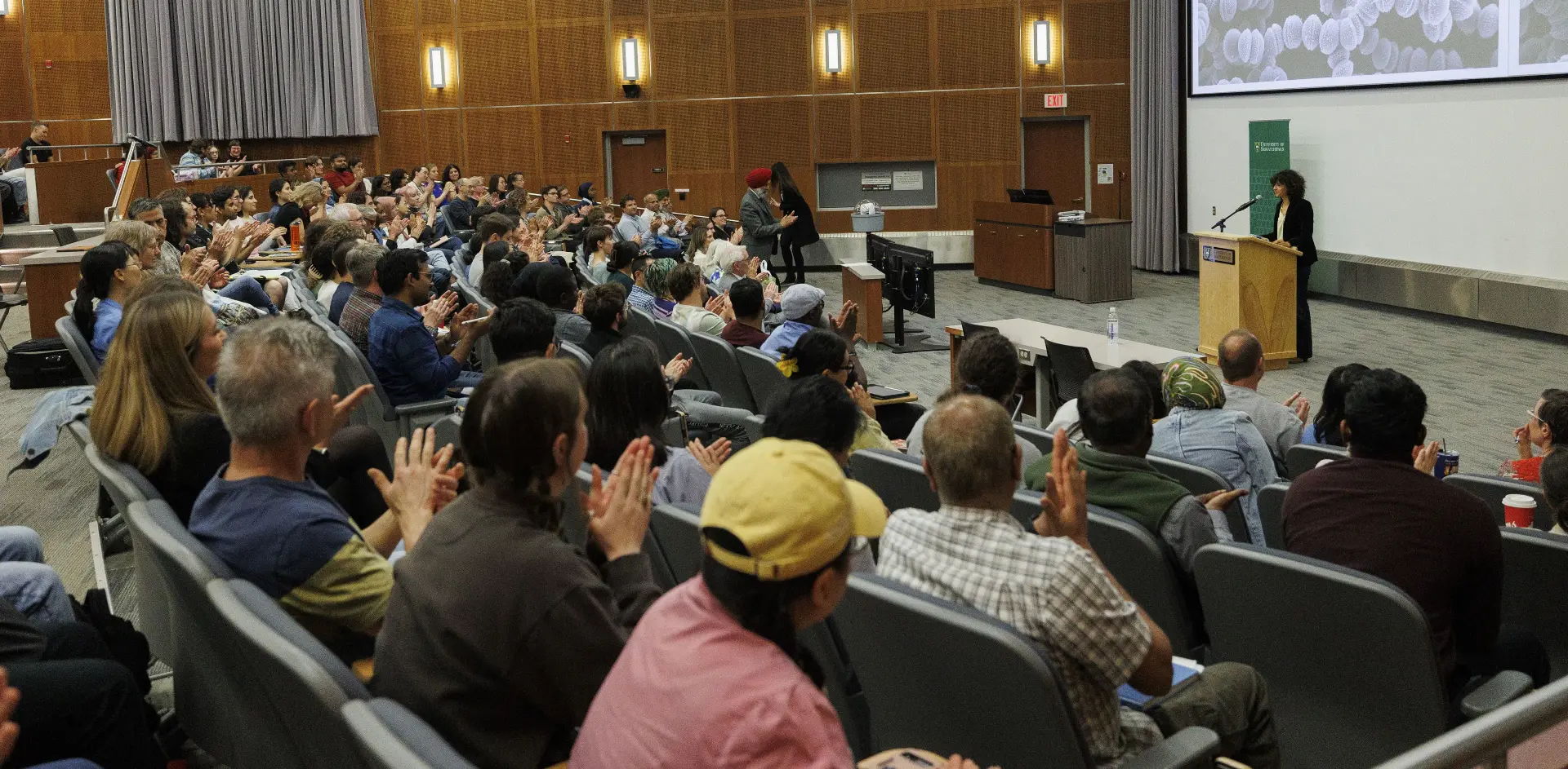 People in a university lecture hall listening to a speaker